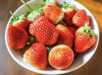 High angle view of strawberries in bowl on table