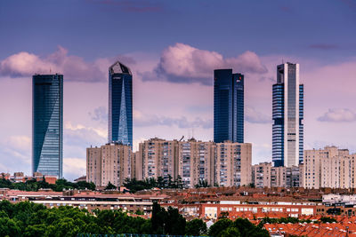 Modern buildings in city against sky