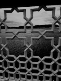 Close-up of chainlink fence against sky