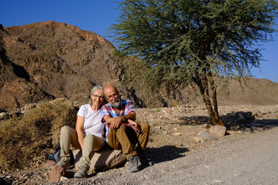 Senior couple sitting in the desert 