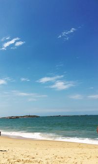 Scenic view of beach against blue sky