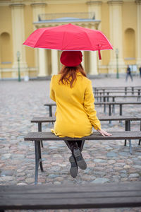 Rear view of woman with umbrella