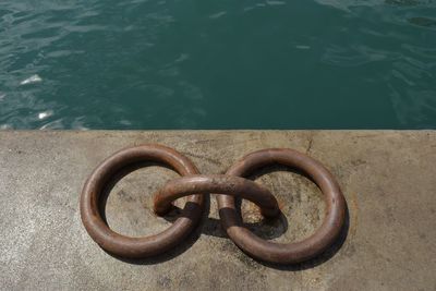 High angle view of metal railing by swimming pool in lake