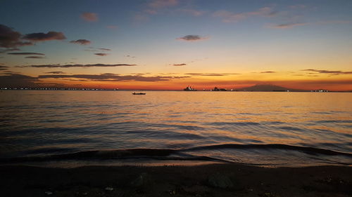 Scenic view of sea against romantic sky at sunset