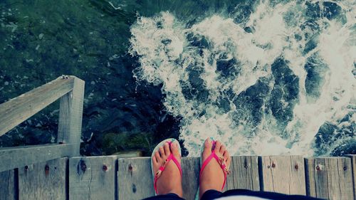 Low section of person standing by railing