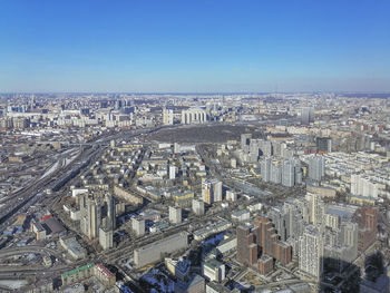 High angle view of city against clear blue sky