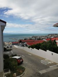 High angle view of buildings by sea against sky