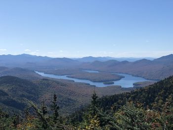 Scenic view of mountains against blue sky