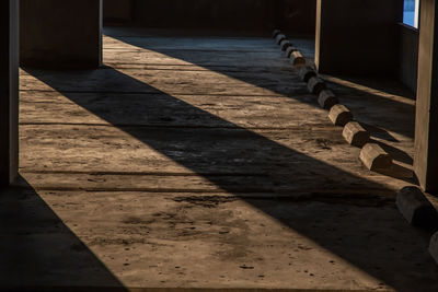 Shadow of railing on footpath