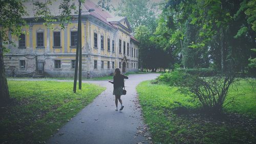 Man walking in front of building