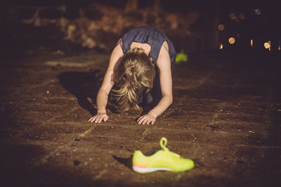 Playful girl on footpath at night