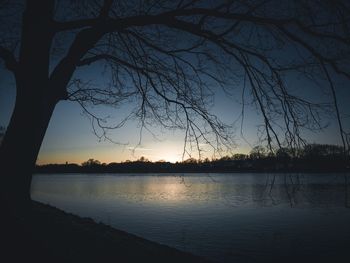 Scenic view of lake against sky at sunset