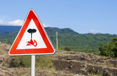 Close-up of road sign against clear sky