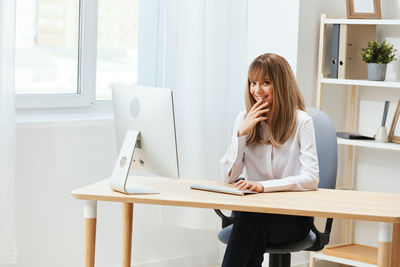 Young woman using laptop at office