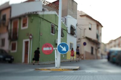 Close-up of road sign against built structures