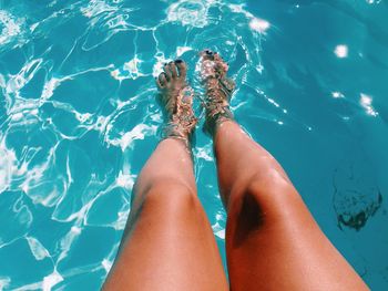 Woman legs in swimming pool