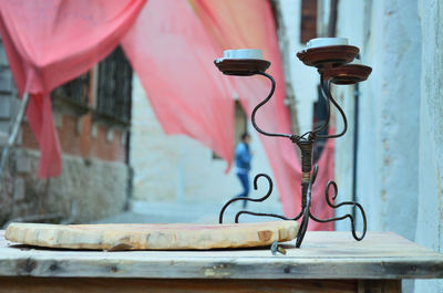 Close-up of electric lamp on old building