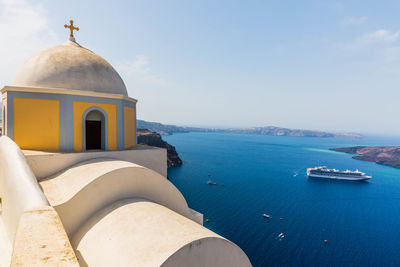 Building by sea against sky