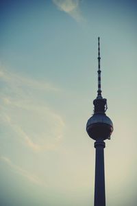 Low angle view of communications tower against sky