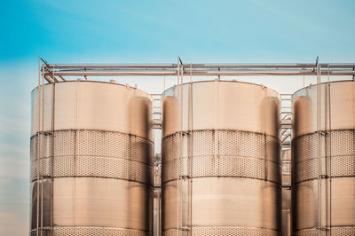 Low angle view of silos against sky