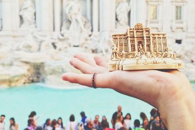 Close-up of people hands against building