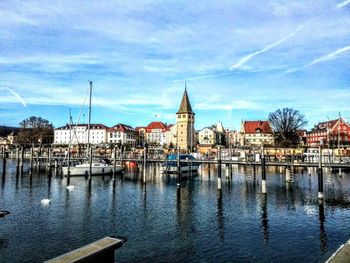 Sailboats in city at waterfront