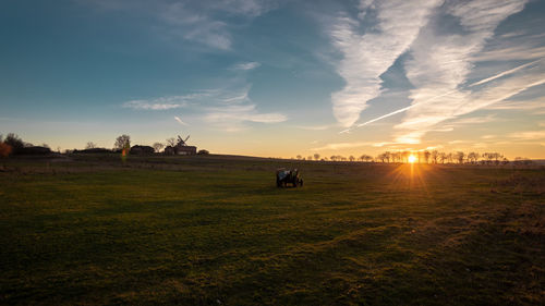 Scenic view of field against sky during sunset