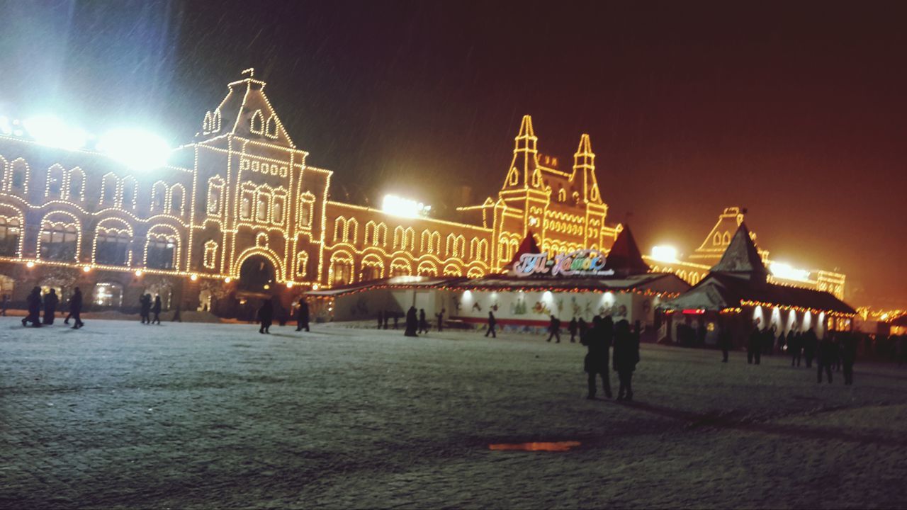 illuminated, night, built structure, large group of people, architecture, sky, lifestyles, leisure activity, men, person, building exterior, arts culture and entertainment, city, tourism, travel destinations, clear sky, dusk, outdoors, famous place