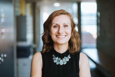 Portrait of confident young woman at home