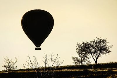 Low angle view of hot air balloons on landscape