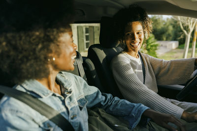 Happy young women sitting in car