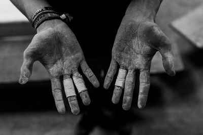 Close-up of human hand against black background