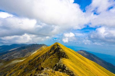 Scenic view of mountain landscape against cloudy sky