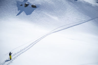 Woman skiing on snow covered mountain