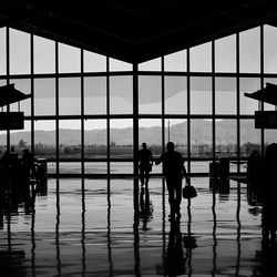 Silhouette of people in glass window