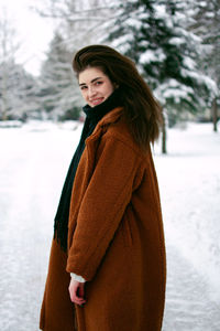 Young woman standing on snow