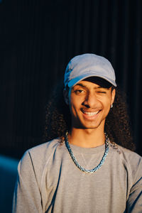 Portrait of smiling young man winking in sunset