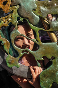 Close-up of young woman holding leaf