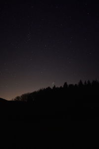 Scenic view of silhouette trees against sky at night