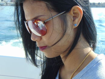 Close-up of young woman wearing sunglasses