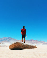Full length of man standing on rock