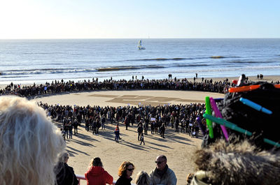 People at beach against sky