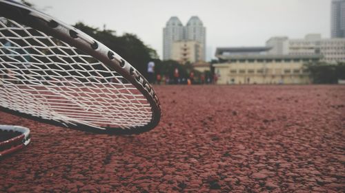 Close-up of badminton rackets on field