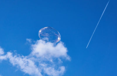 Low angle view of moon against blue sky