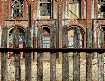 Old building seen through metal fence