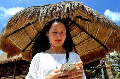 Low angle view of woman using smart phone