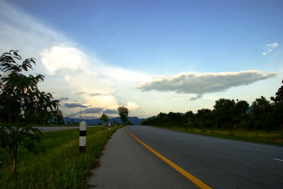 Empty road along countryside landscape