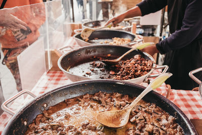 Variety of take away curries on sale of a street food market, selective focus.