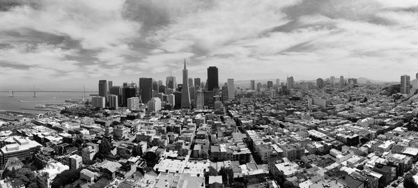 Panoramic view of cityscape against cloudy sky