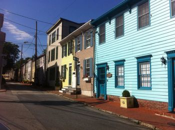 View of residential buildings against blue sky